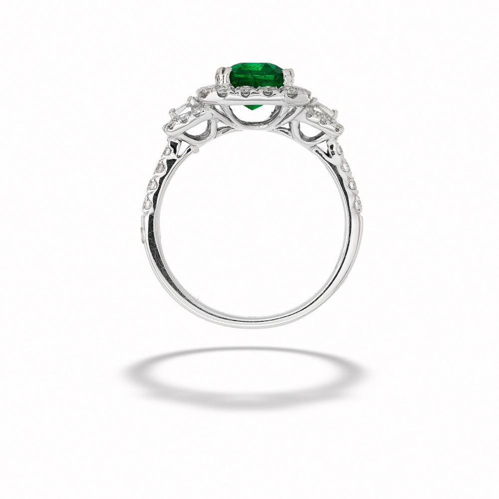 Silver ring with a green gemstone on a white background Emerald Halo Ring