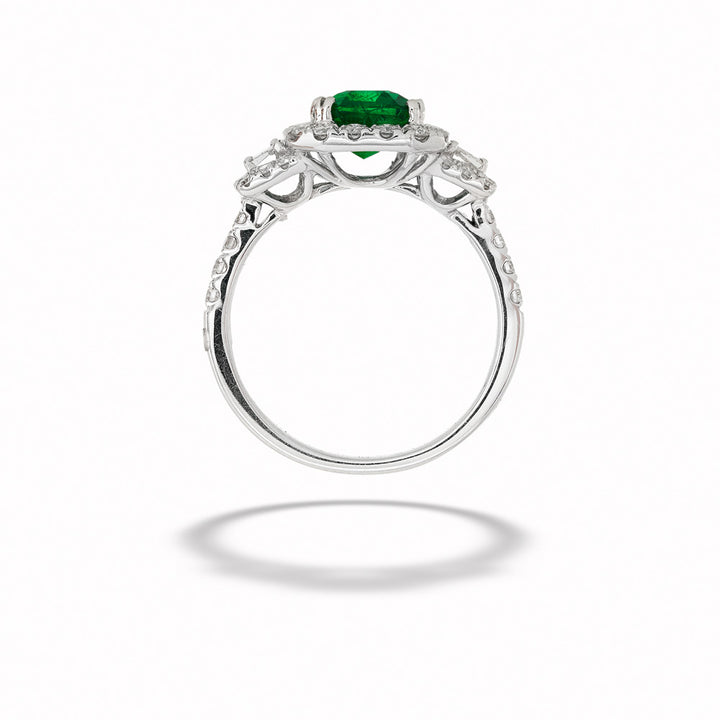 Silver ring with a green gemstone on a white background Emerald Halo Ring