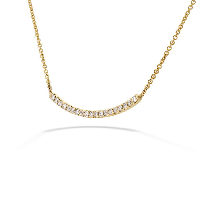 Gold necklace with small diamonds on a white background 14K Gold Diamond Curved Bar Necklace