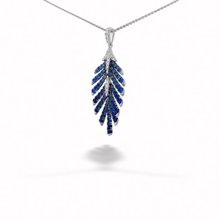 Silver necklace with a blue gemstone pendant on a white background Sapphire and Diamond Leaf Pendant Necklace