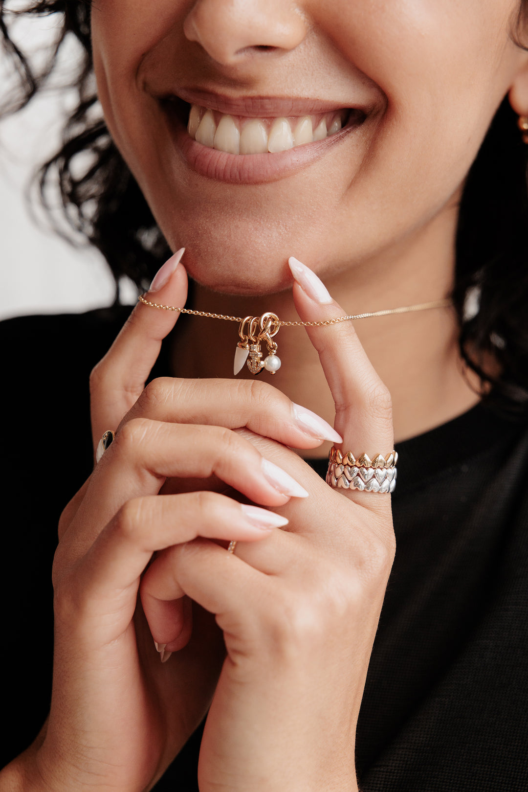 pandora model wearing charm necklace and 2 rings
