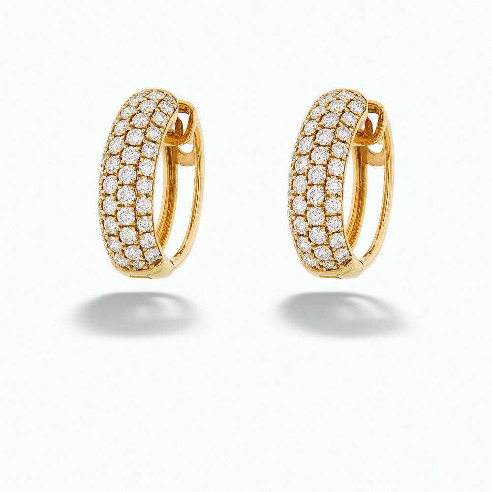 Gold hoop earrings with diamond accents on a white background Diamond Studded Hoop Earrings