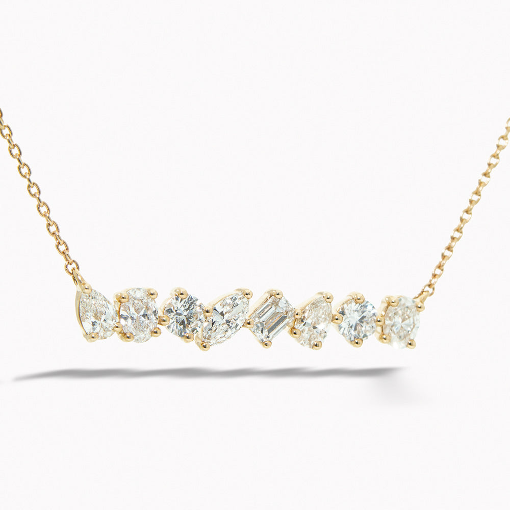 Gold necklace with diamond pendants on a white background Multi-Shape Diamond Bar Necklace