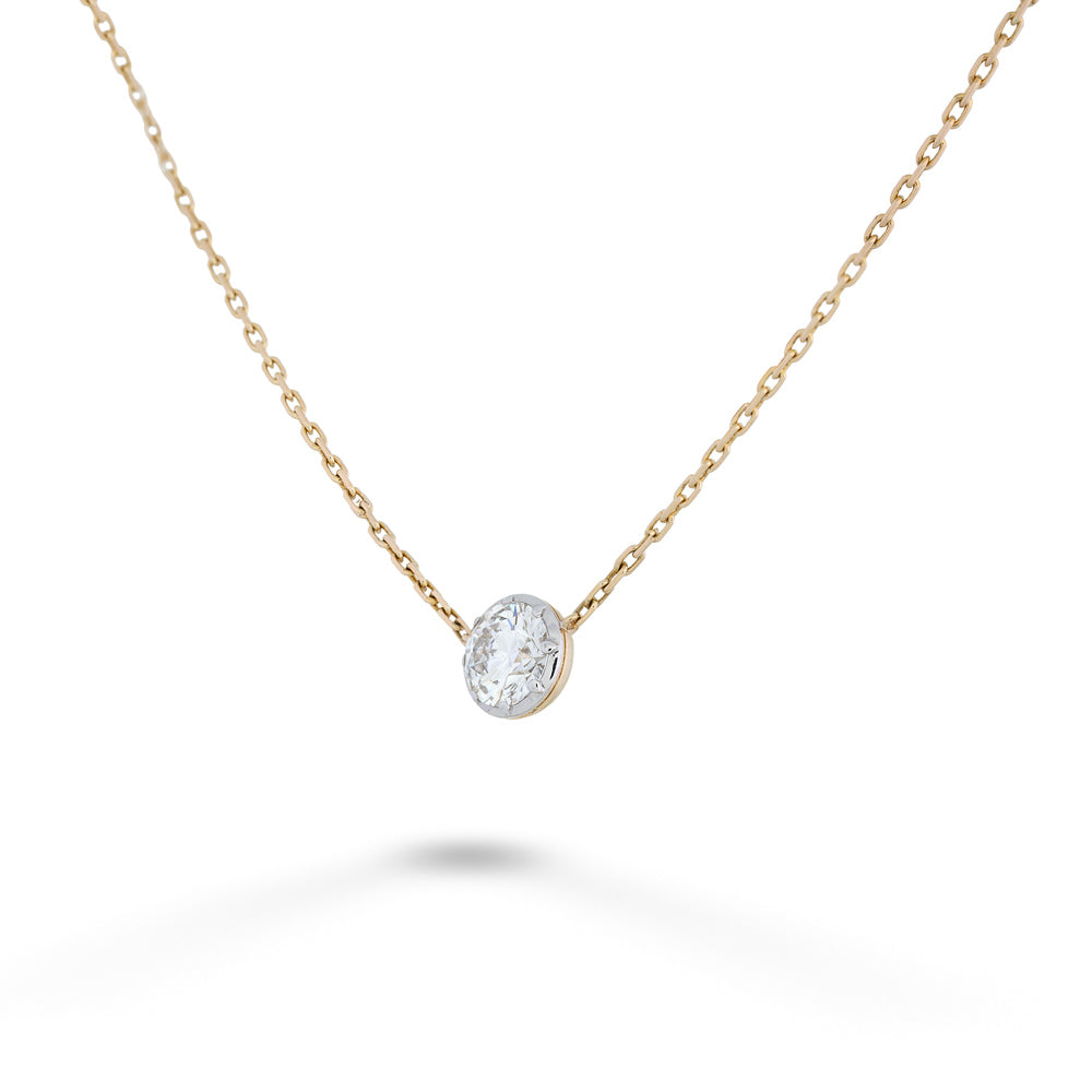 Gold necklace with a diamond pendant on a white background Round Lab Grown Diamond Solitaire Necklace by Miss Mimi