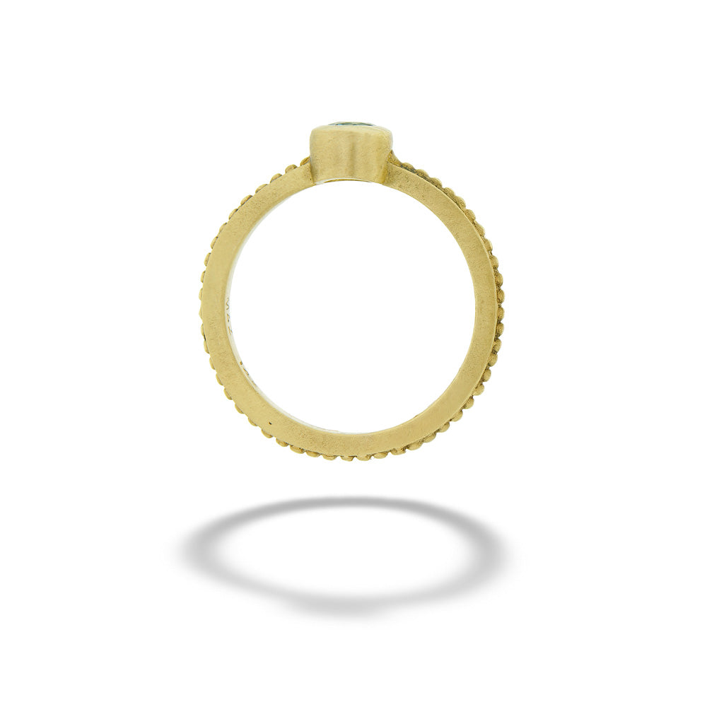 Gold ring with a small gemstone on a white background Blue Topaz Ring by Mazza