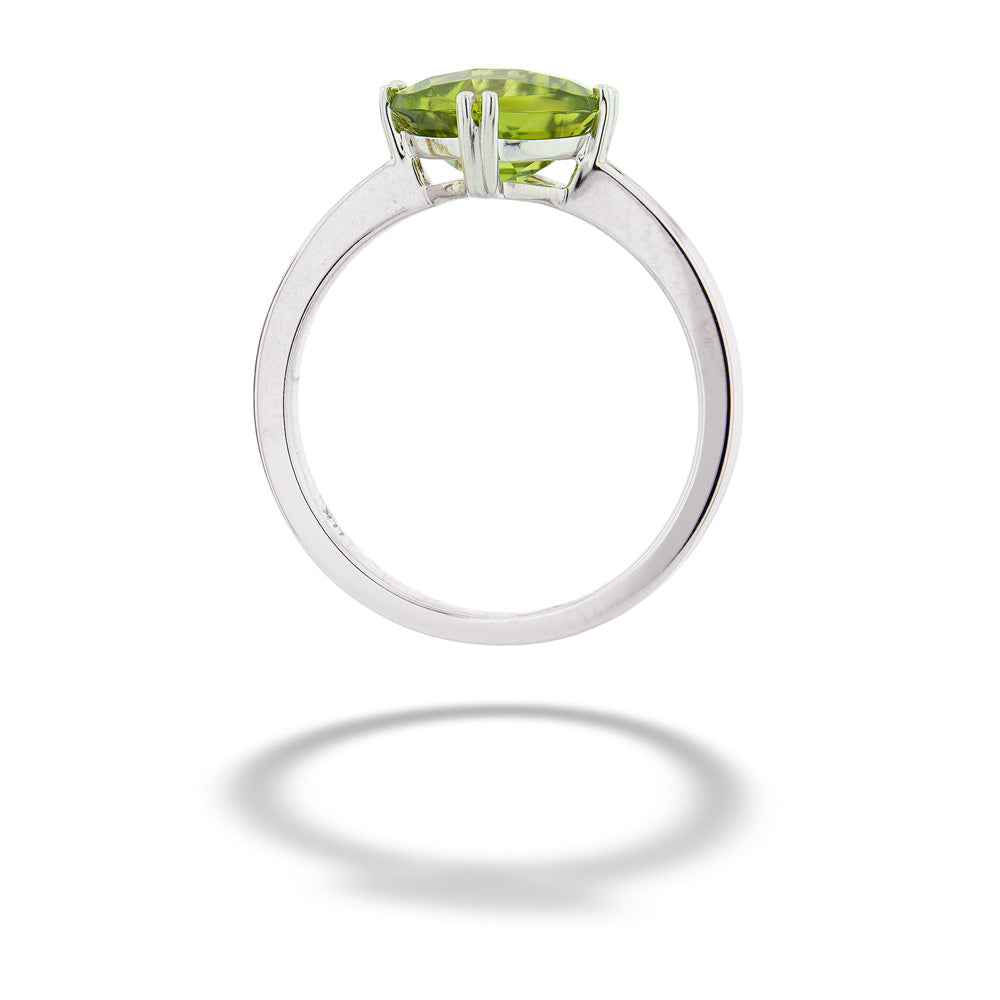Silver ring with a green gemstone on a white background Peridot Solitaire Ring