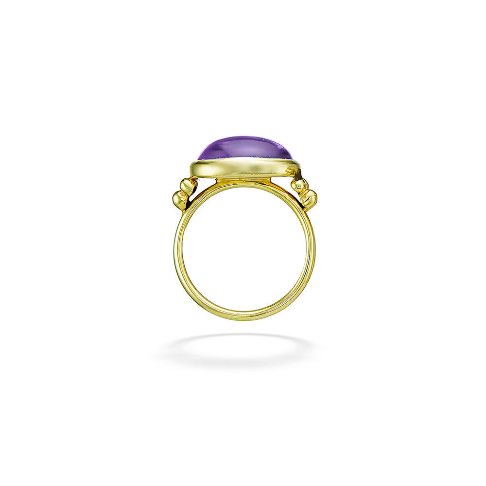Gold ring with a purple gemstone