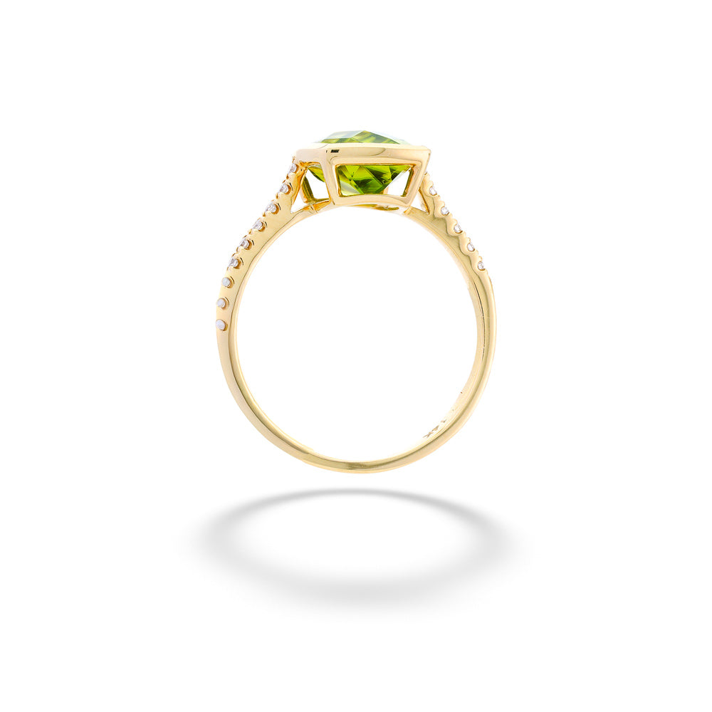Gold ring with a green gemstone on a white background Peridot Ring with Diamond Band