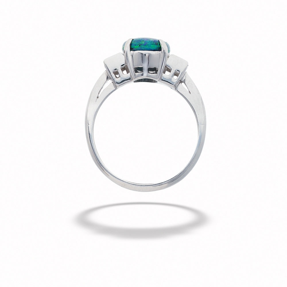 Silver ring with a green gemstone on a white background  Black Opal and Diamond Ring 