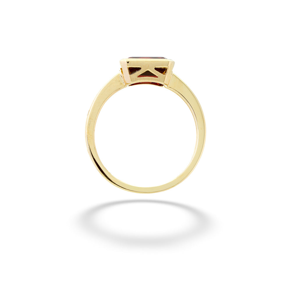 Gold ring with a diamond on a white background Garnet Ring by Shy Creation