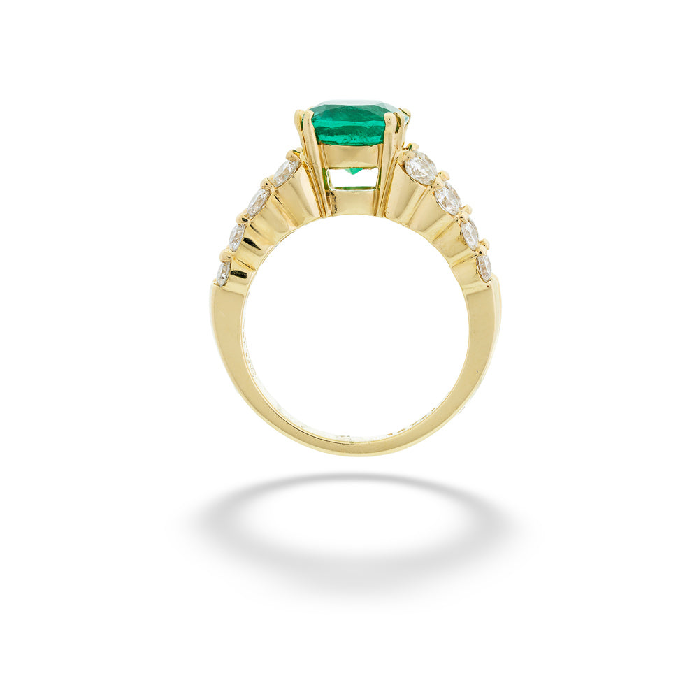 Gold ring with a green gemstone and diamond accents on a white 18K Yellow Gold Emerald and Diamond Ring background