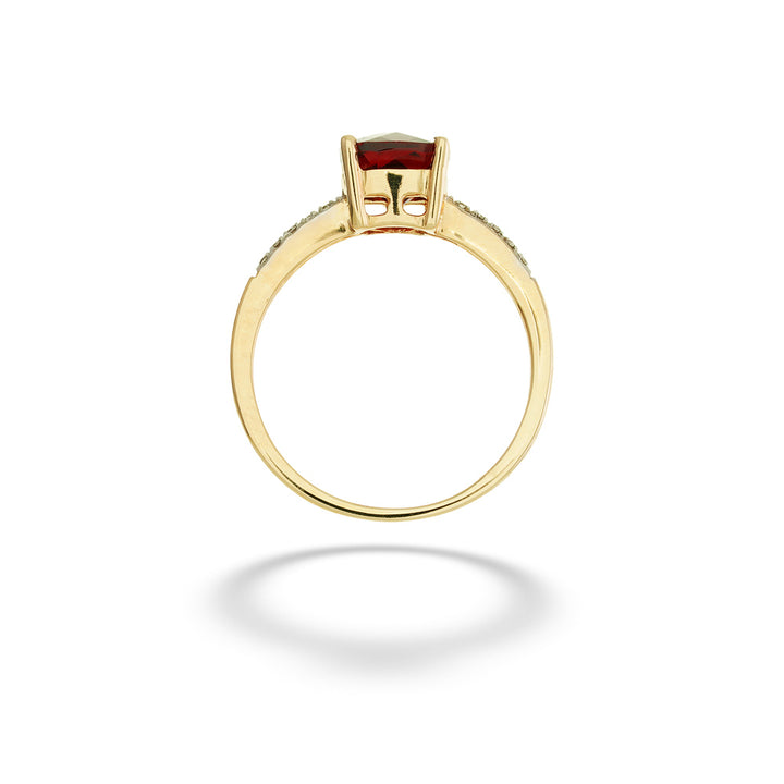 A gold ring with a rectangular red gemstone in a prong setting, shown from a top-down view on a white background with a soft shadow. Cushion-Cut Garnet and Diamond Ring 