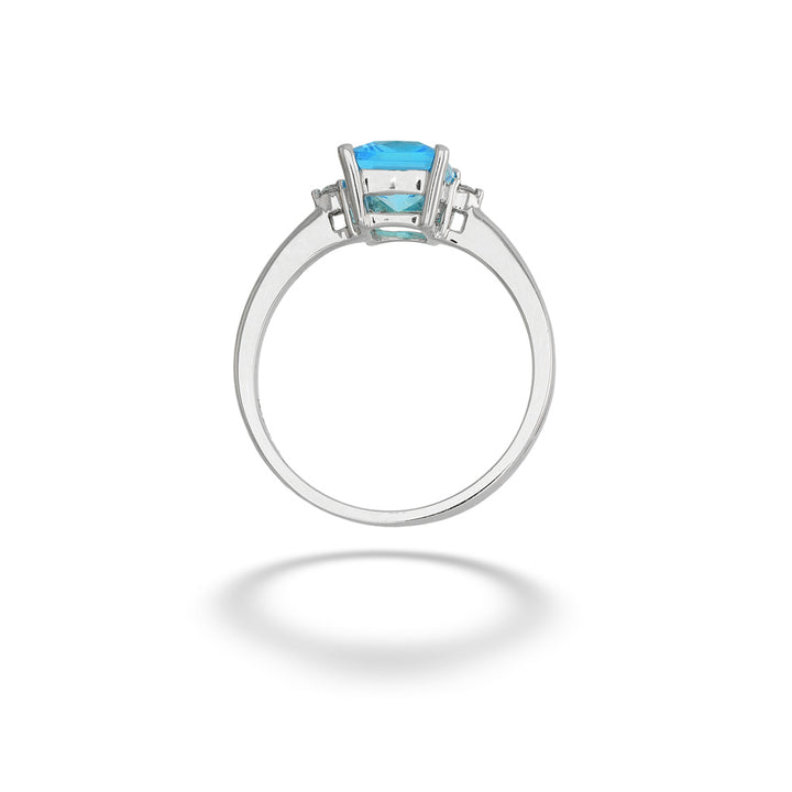 A silver ring featuring a square-cut light blue gemstone in a prong setting, shown against a plain white background with a soft shadow below. Blue Topaz and Diamond Ring
