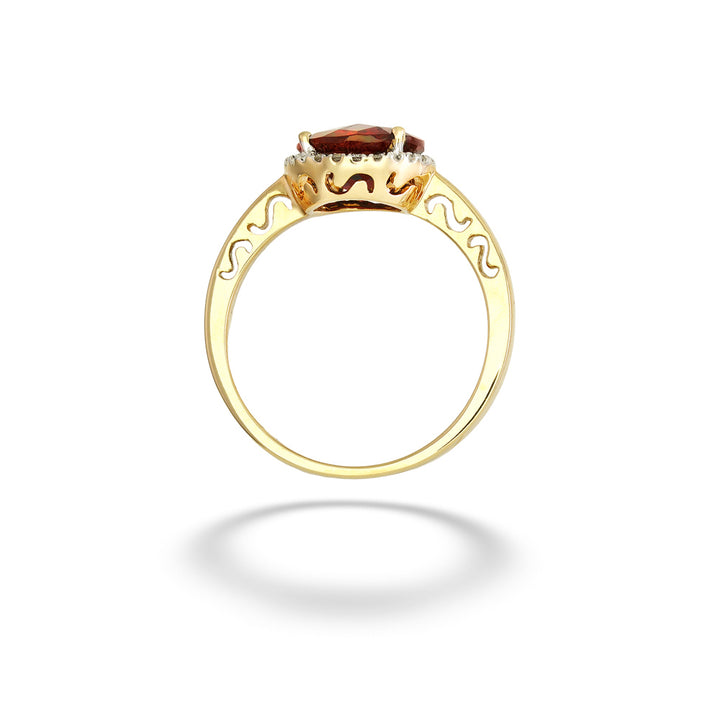 A gold ring with a central oval brown gemstone, surrounded by small clear stones and decorative scrollwork on the band, shown on a white background with a soft shadow. Garnet with Diamond Halo Ring