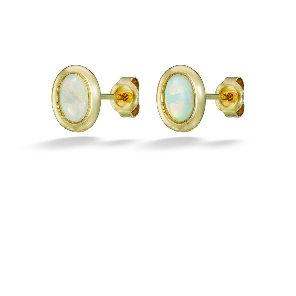 Gold earrings with opal stones on a white background