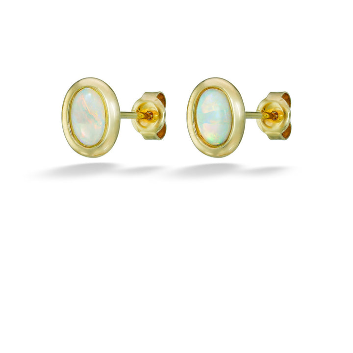Gold earrings with opal stones on a white background