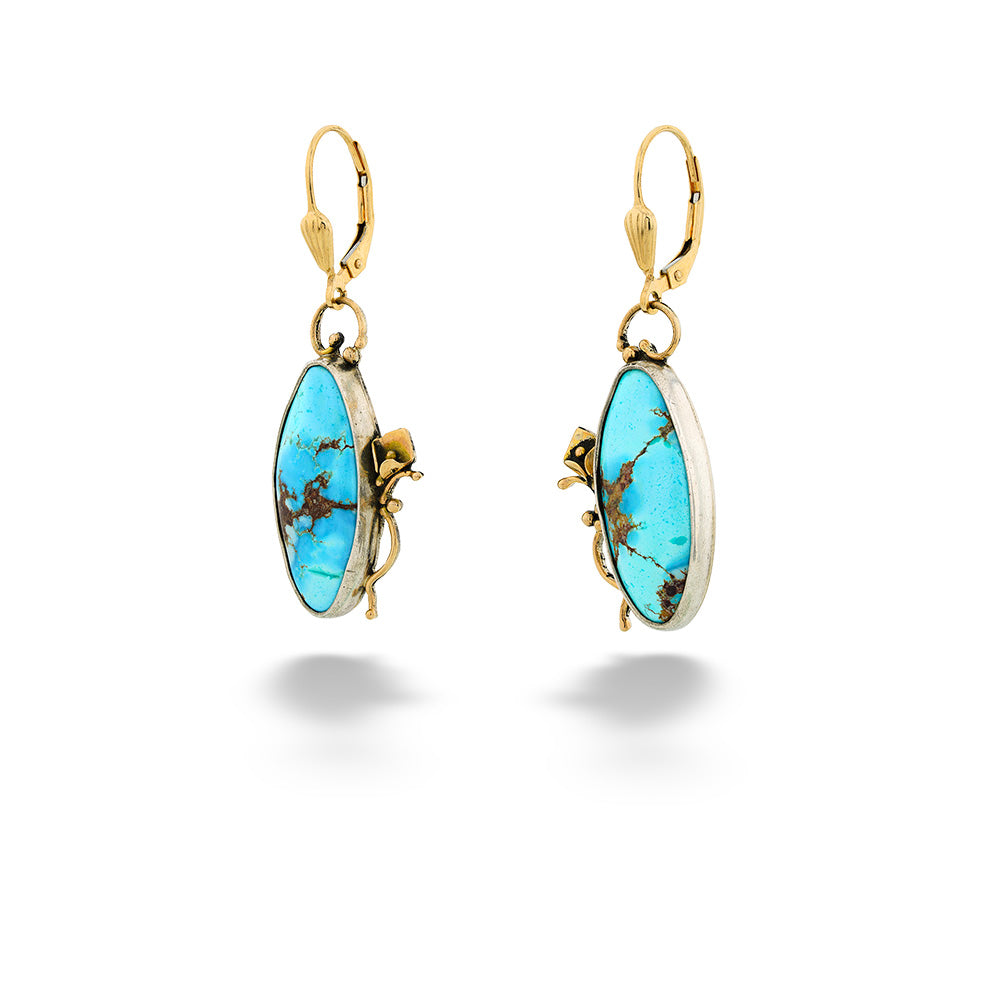 Gold earrings with turquoise stones on a white background Turquoise Dangle Earrings