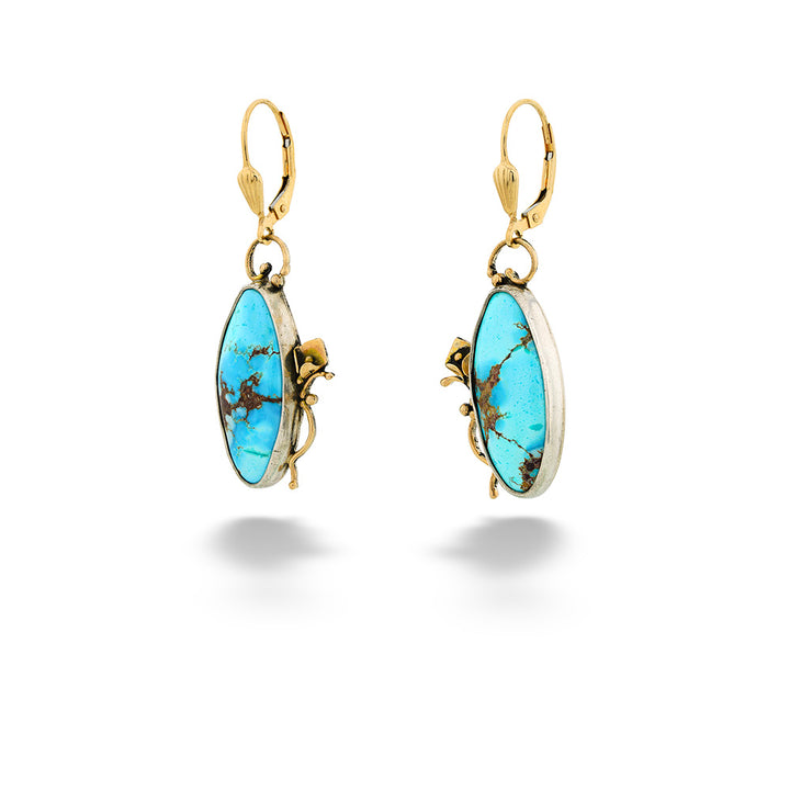 Gold earrings with turquoise stones on a white background Turquoise Dangle Earrings
