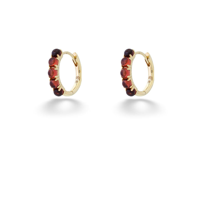 Gold hoop earrings with red gemstones on a white background Garnet Huggie Earrings by Shy Creation