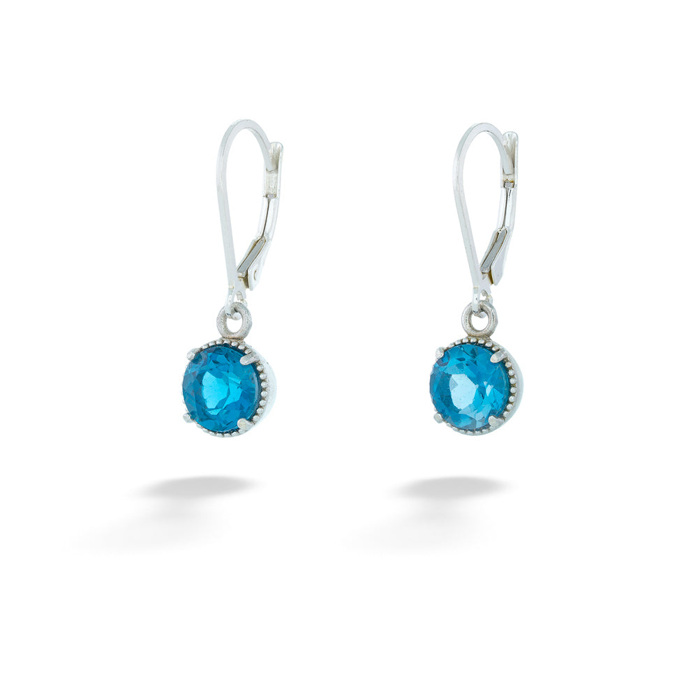 Pair of silver earrings with blue gemstones on a white background London Blue Topaz Dangle Earrings by Anatoli