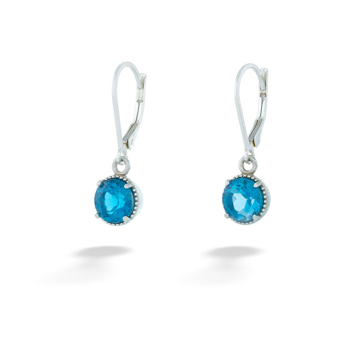 Pair of silver earrings with blue gemstones on a white background London Blue Topaz Dangle Earrings by Anatoli