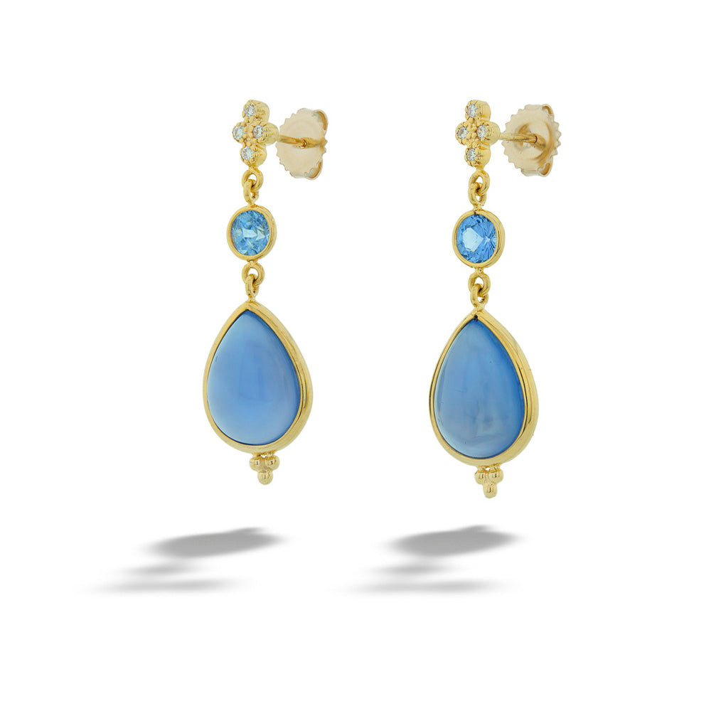 Pair of gold earrings with blue teardrop stones on a white background 14K Gold Sapphire and Chalcedony Earrings by Mazza