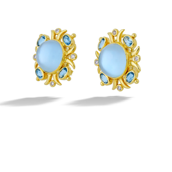 Gold earrings with light blue gemstones on a white background Blue Topaz, Mother of Pearl, and Diamond Earrings by Mazza