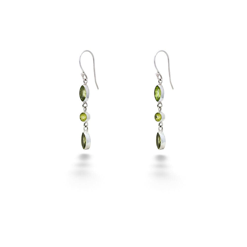 Pair of silver earrings with green gemstones on a white background Multi-Shape Peridot Drop Earrings by Samuel B.