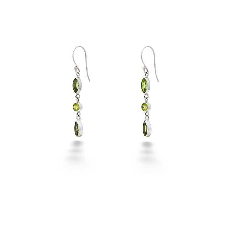 Pair of silver earrings with green gemstones on a white background Multi-Shape Peridot Drop Earrings by Samuel B.