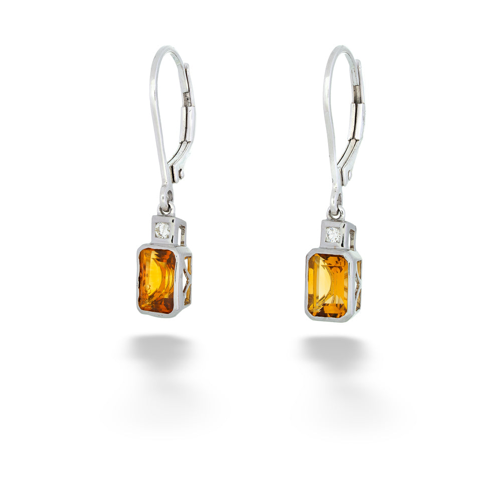 Pair of silver earrings with rectangular yellow gemstones on a white Emerald Cut Citrine Dangle Earrings background