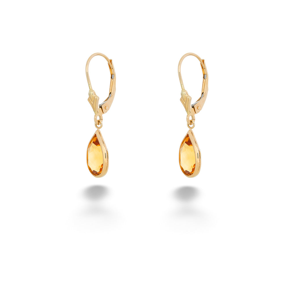Gold teardrop earrings on a white background Pear Shape Citrine Dangle Earrings