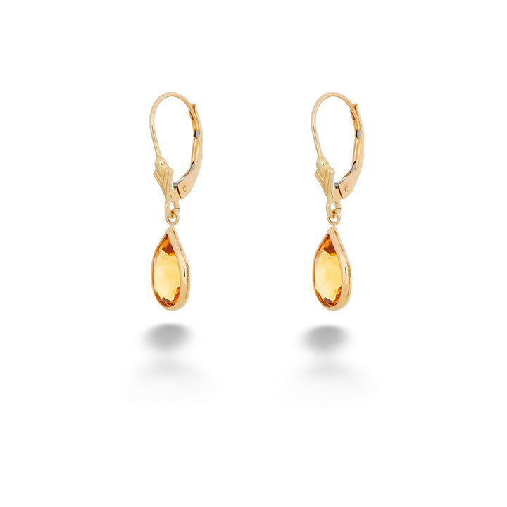 Gold teardrop earrings on a white background Pear Shape Citrine Dangle Earrings