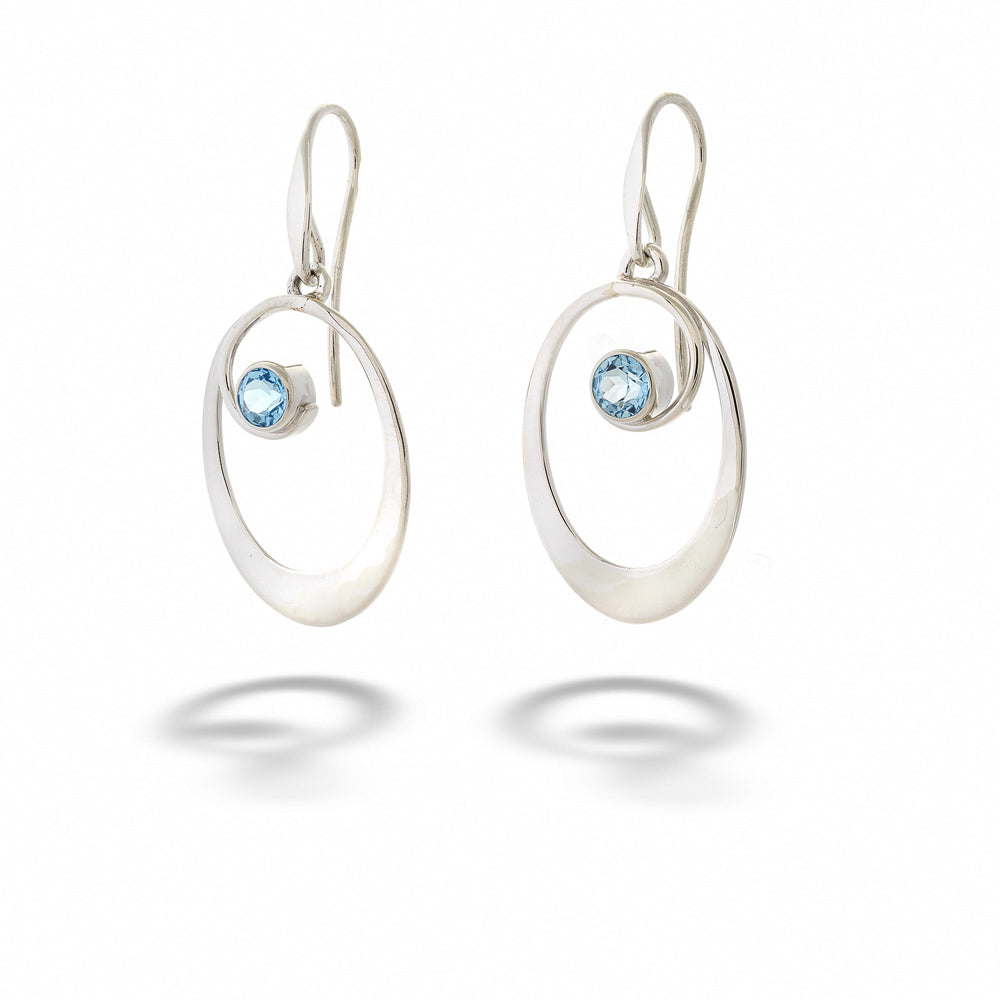Silver earrings with blue gemstones on a white background Blue Topaz “Sophia” Earrings by E.L. Designs