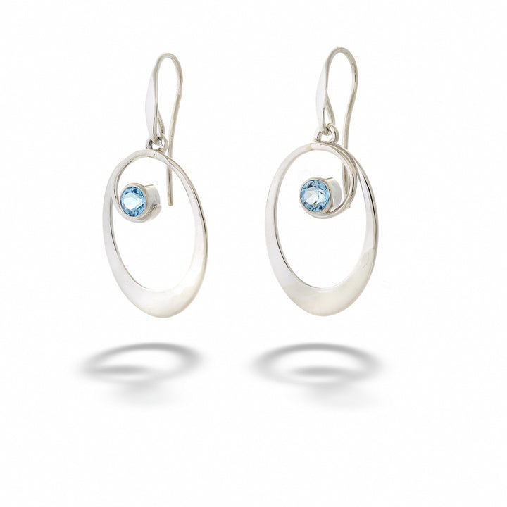 Silver earrings with blue gemstones on a white background Blue Topaz “Sophia” Earrings by E.L. Designs