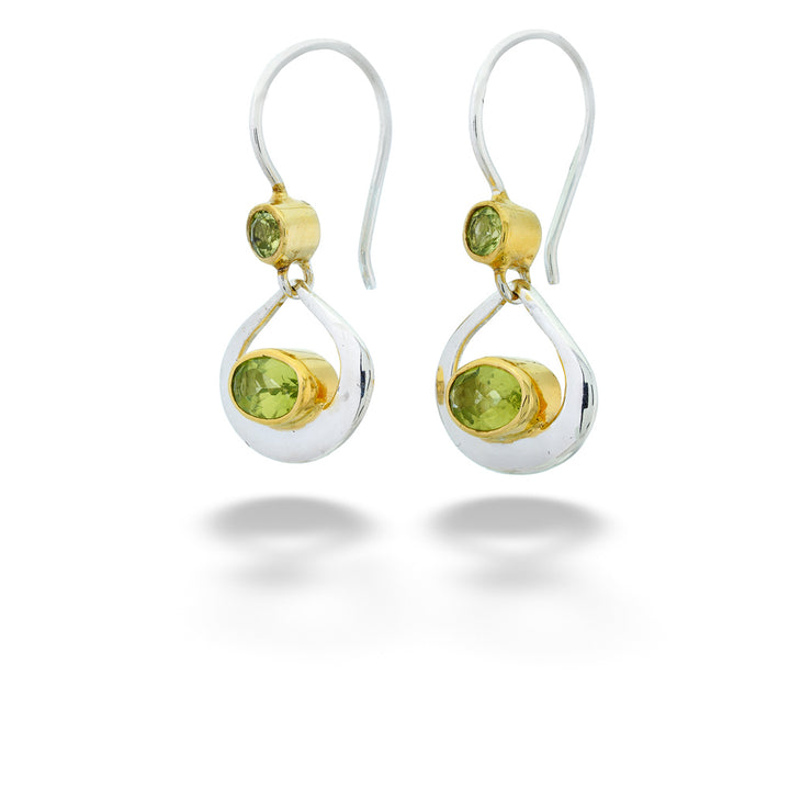 Pair of earrings with green gemstones on a white background Peridot Dangle Earrings by Michou