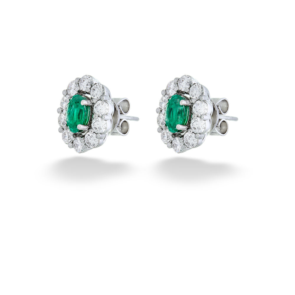 Pair of emerald and diamond earrings on a white background  Emerald and Diamond Halo Earrings 