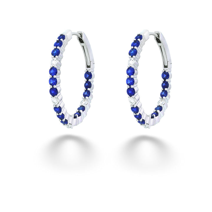 Pair of hoop earrings with blue and clear gemstones on a white background Sapphire and Diamond Inside/Out Hoops