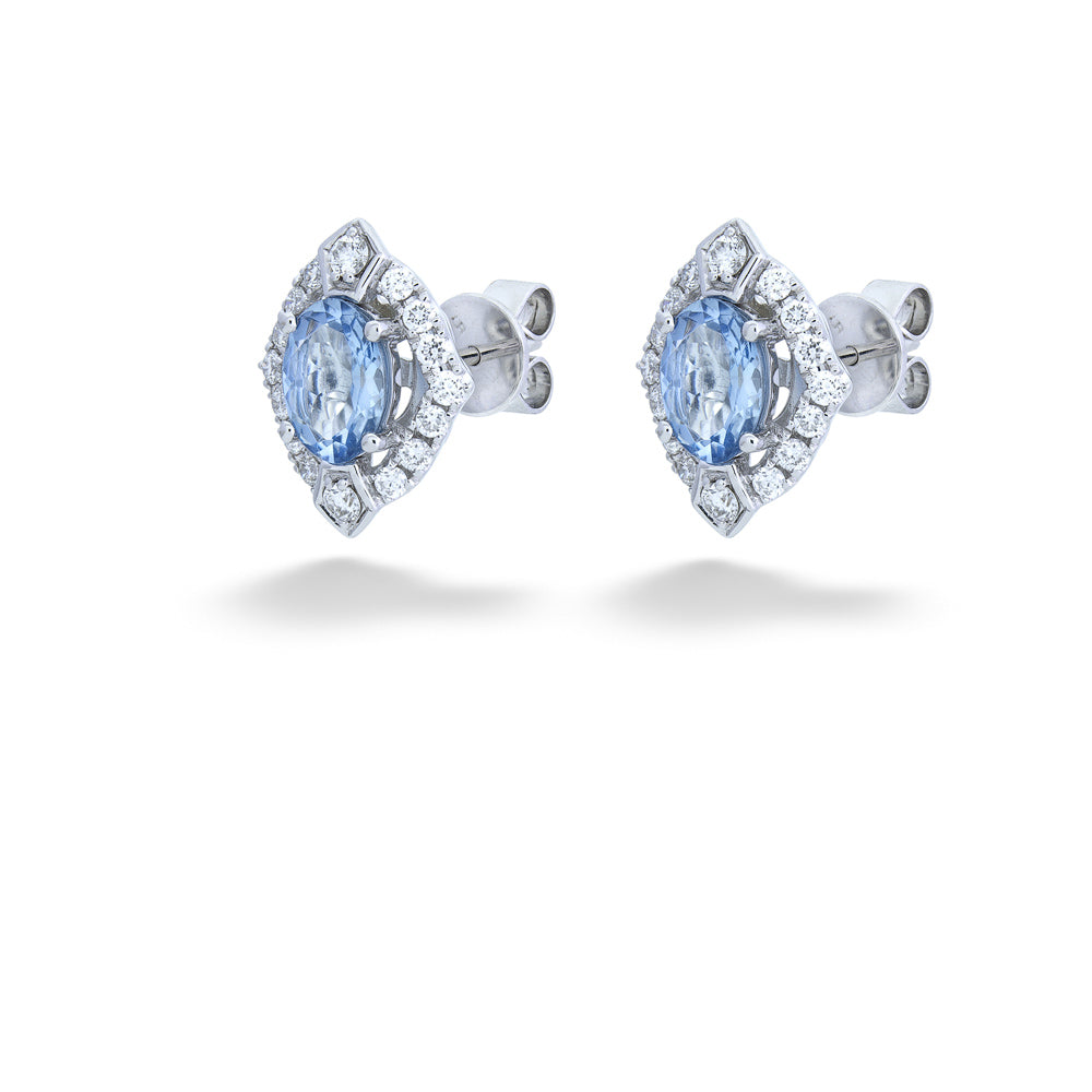 Pair of earrings with blue gemstones and diamond-like accents on a white background Aquamarine and Diamond Stud Earrings