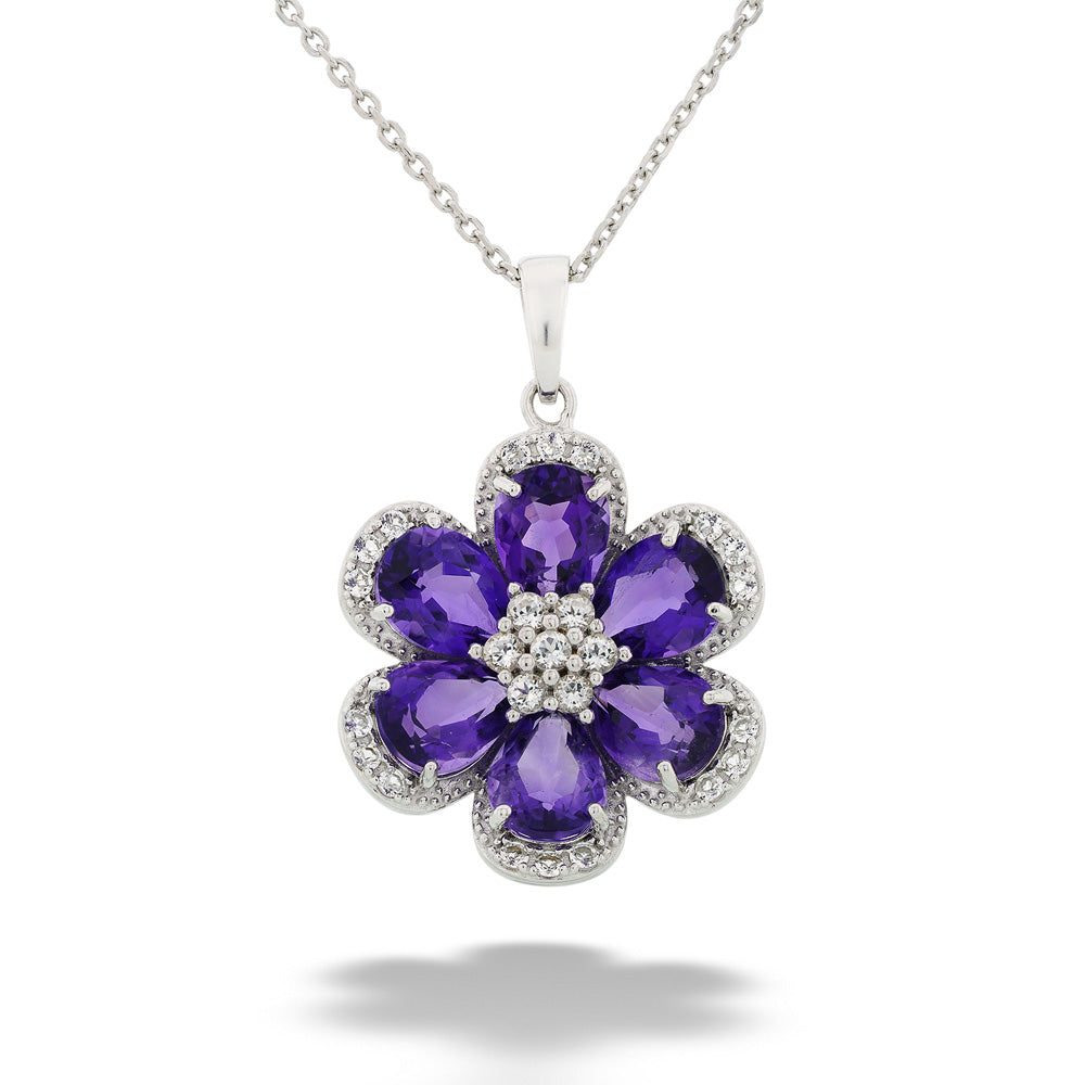 Floral pendant with purple gemstones and clear stones on a white background Amethyst and White Topaz Flower Pendant Necklace by Samuel B.