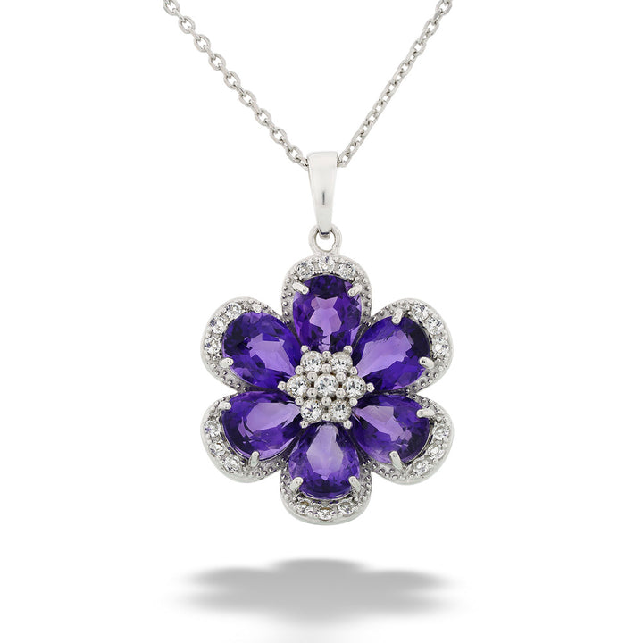 Floral pendant with purple gemstones and clear stones on a white background Amethyst and White Topaz Flower Pendant Necklace by Samuel B.