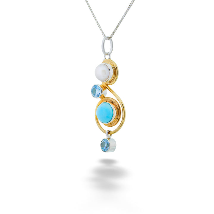 Jewelry pendant with gold and silver elements and blue gemstones on a white background Turquoise, Pearl & Blue Topaz Pendant Necklace by Michou