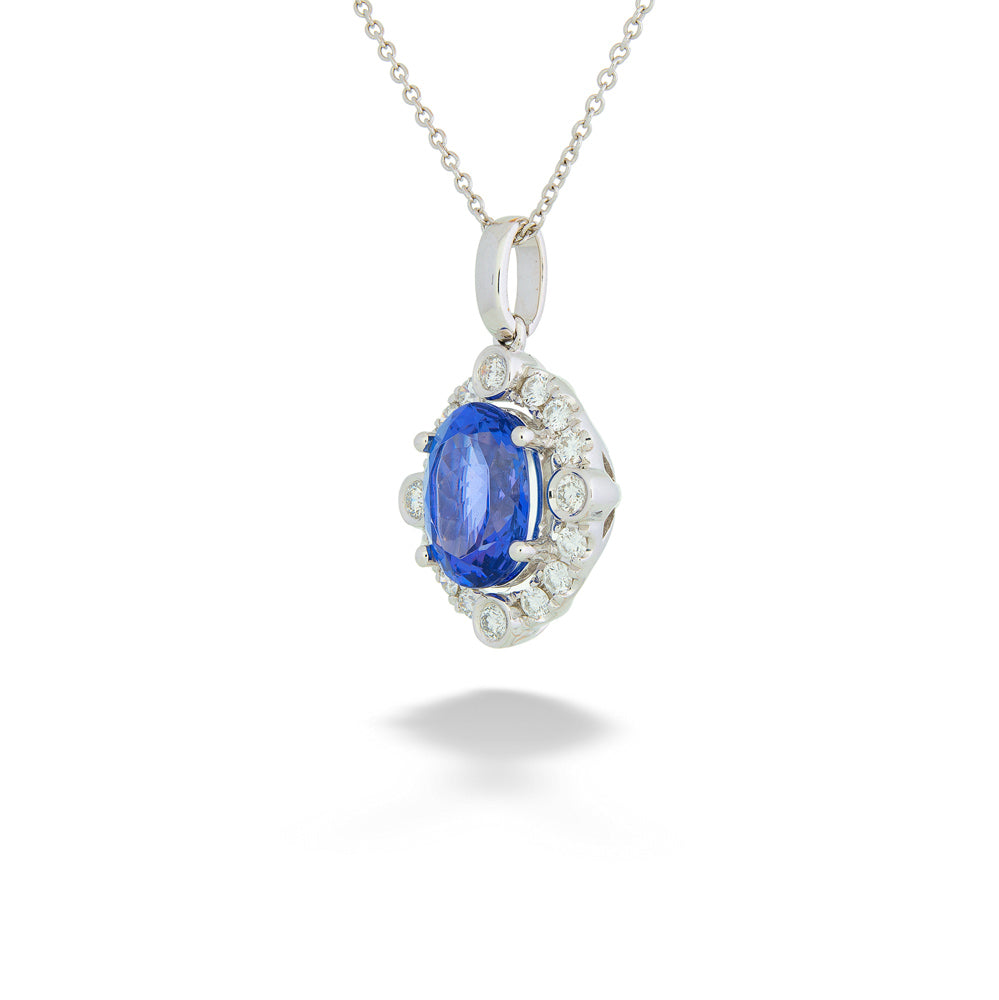 Silver pendant with a blue gemstone and diamond accents on a white Tanzanite and Diamond Pendant Necklace background