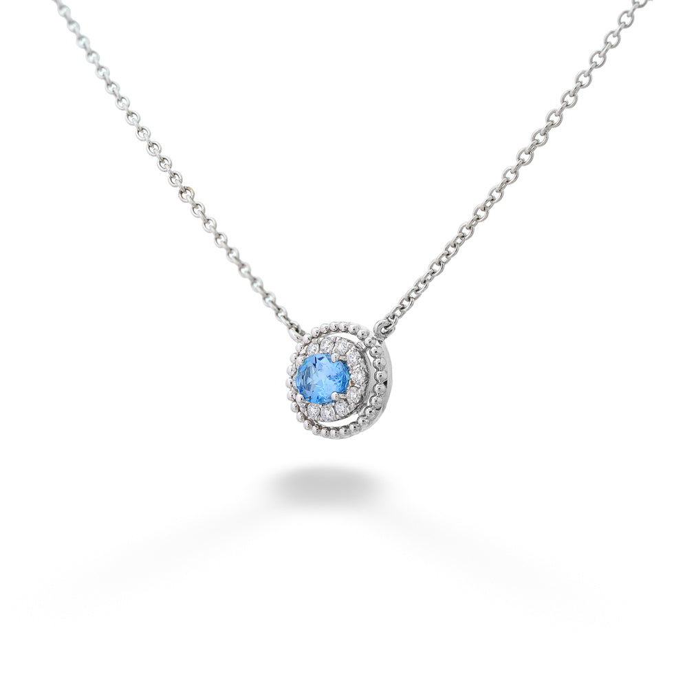 Necklace with a blue gemstone pendant on a white background Aquamarine with Diamond Halo Beaded Edge Necklace