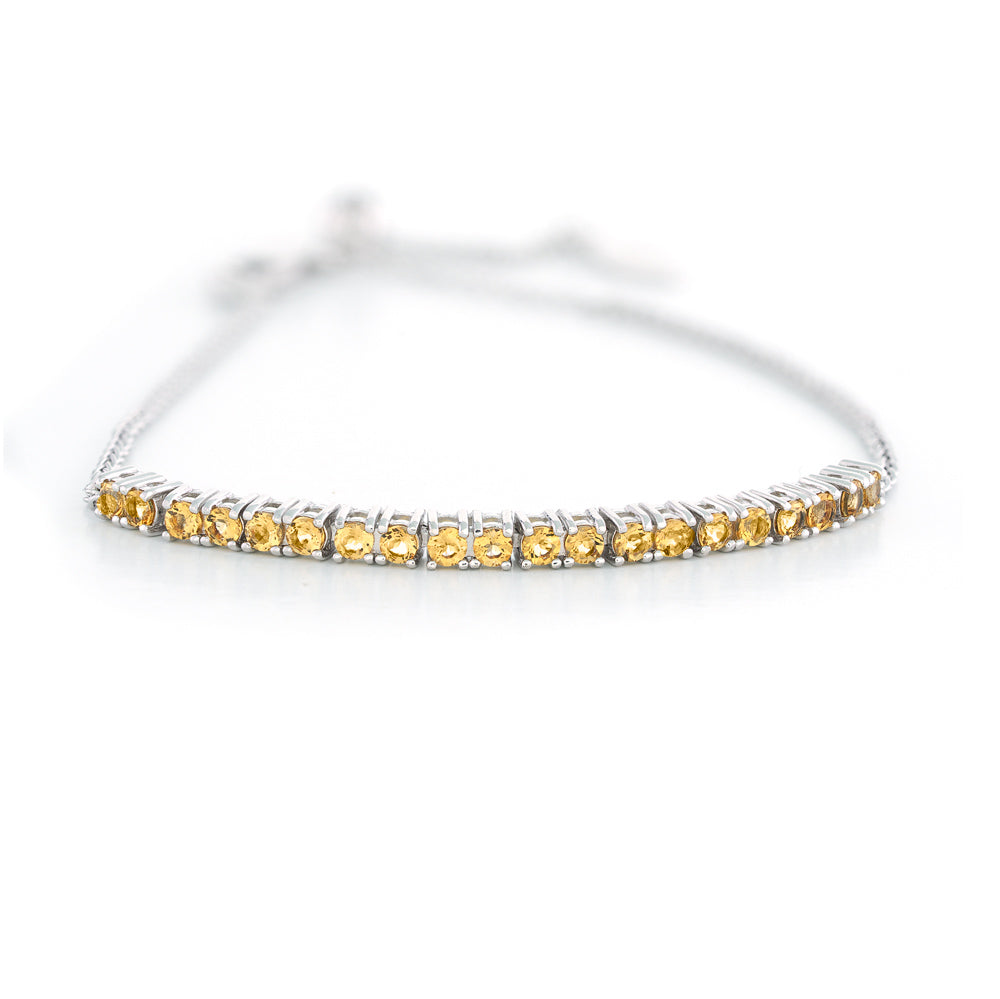 Silver bracelet with yellow gemstones on a white background Adjustable Citrine Bar Bracelet by Samuel B.