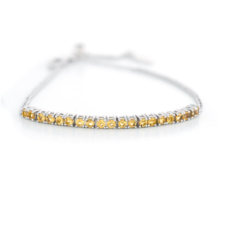 Silver bracelet with yellow gemstones on a white background Adjustable Citrine Bar Bracelet by Samuel B.