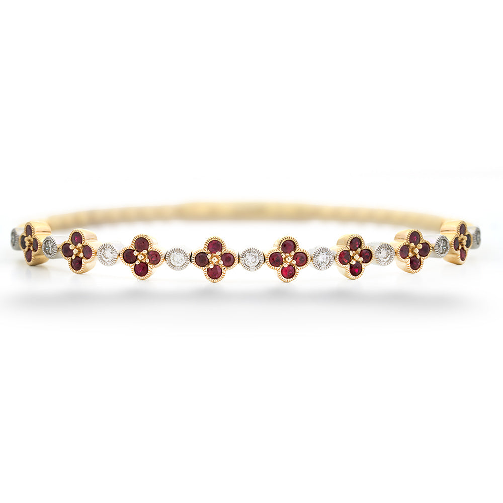 Gold bracelet with red gemstones and diamonds on a white background Ruby Clover and Diamond Bangle