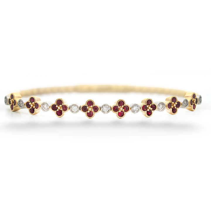 Gold bracelet with red gemstones and diamonds on a white background Ruby Clover and Diamond Bangle