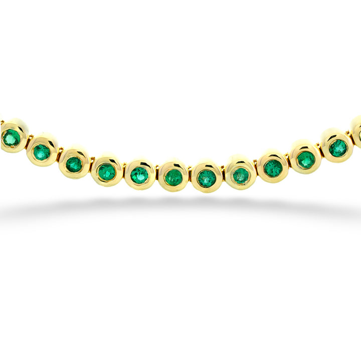 Gold bracelet with green gemstones on a white background Emerald Line Bracelet by Shy Creation