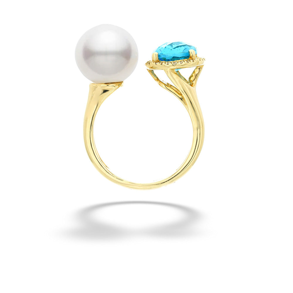 Gold ring with a pearl and turquoise stone on a white background Pearl and Blue Topaz Ring