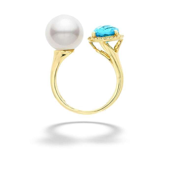Gold ring with a pearl and turquoise stone on a white background Pearl and Blue Topaz Ring